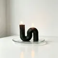 Detailed view of a black geometric S-shaped scented candle with vertical grooves. - Large S-Shape / 10x10x3cm Box / Black