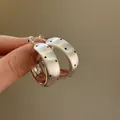 Detail of brushed silver C-shaped hoop earrings with elegant black polka dot pattern - Polka Dot Wide Hoop (60# 925 Sterling Silver Earring Post) / Silver