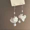 Close-up detail of pleated white resin flower tassel earrings with elegant pearl accents - 23# Ear Clip - White (Pearl Shell Flower Tassel)