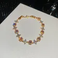 Elegant gold plated bracelet featuring pink zircon flowers and sparkling crystals. - 40# Bracelet / Gold Pink