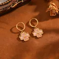 Detailed macro view of 18k gold plated four-leaf clover hoop earrings with pink stones - T063 Kumquat Four-leaf Clover Earrings