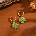 Detailed view of 18k gold plated four-leaf clover hoop earrings with green cat-eye stones - T063 Golden Blue Four-leaf Clover Earrings