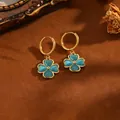 Detail view of 18k gold plated stainless steel four-leaf clover hoop earrings in blue. - Four-leaf Clover Ear Buckle / Gold with Blue