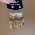 Boucles d'oreilles vintage dorées à franges style ethnique avec perles bleues - Boucles d'Oreilles Clous à Glands en Métal en Forme de Plume Vintage (48#) / Or