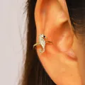 Close-up view of a luxury gold seahorse ear cuff encrusted with sparkling white zircon stones - Seahorse (12247) / Gold
