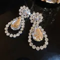 Close-up of luxury teardrop crystal earrings with brilliant rhinestone detailing - Silver