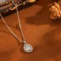 Close-up detail of an oval silver necklace pendant with sparkling baguette diamonds - Oval Locket / Silver