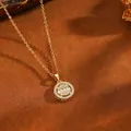 Detail view of a luxury gold stainless steel necklace with crystal-encrusted round pendant - Round Pendant / Gold