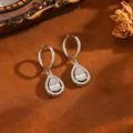 Detailed view of silver stainless steel waterdrop earrings with sparkling baguette stones - Water Drop Earrings / Silver