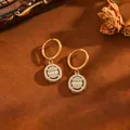 Close-up of gold-plated 304 stainless steel hoop earrings with crystal pendants - Oval Earrings / Gold