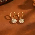 Detail of circular 304 stainless steel hoop earrings with crystal pave pendant - Graduated Bead Hoop Earrings / Gold