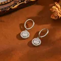 Close-up detail of silver stainless steel round hoop earrings with pavé set crystals. - Graduated Bead Hoop Earrings / Silver