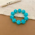 Close-up detail of vibrant turquoise acrylic beads on a summer dopamine style bracelet - Bracelet / Sky Blue