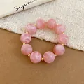 Elegant pink acrylic beaded bracelet featuring a marble texture and gold spacers - Bracelet / Pink