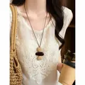 Detailed view of a retro ethnic resin necklace with brown and beige textured beads - Model 4 Necklace / Brown