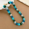 Close-up detail of acrylic beaded necklace with blue, green, and marble white beads. - Blue-Green Marble Round Bead Necklace (45#) / Gold-Green Blue Mixed