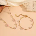 Detail of pink and white beaded flower charms on gold titanium steel chain set - Pink and White Flower Necklace and Bracelet Set (D621-D620)