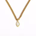 Close-up detail of a gold marquise-cut zircon pendant on a stainless steel chain. - White