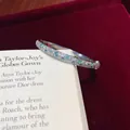 Close-up of an elegant silver bangle with sparkling mint blue and white crystal pavé - Bangle / Silver-Blue