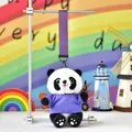 Adorable panda plush doll keychain wearing a purple t-shirt hanging on a display stand - Purple