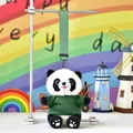 Cute panda plush keychain wearing a green shirt hanging on a display stand - Green