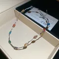 Gedetailleerde weergave van kleurrijke edelsteenketting met zilveren golfketting. - Ketting / Zilver - Regenboog