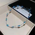 Detailweergave van een zilveren ketting met blauwe edelstenen in een luxe geschenkdoos - Ketting / Zilver-Blauw