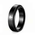 Detailed macro view of a black rotatable stainless steel spinner ring with a white cross - Size 5 / Black
