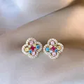 Detailed macro view of elegant flower stud earrings with vibrant colorful crystals - Real Gold Plated Silver Needle Style / Gold/Multicolor