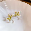 Macro view of orchid flower silver stud earrings with delicate green enamel finish - 48# Orchid Shape Stud Earrings / Silver-Green