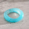 Detail shot of light blue resin marbling oval concave bangle with artistic swirl effect - Sky Blue