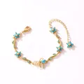 Vue détaillée du bracelet branche fleurie dorée avec pierres bleues style turquoise - Style Horizontal-Or-Zirconia Turquoise