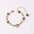 Bracelet doré exquis avec des fleurs en zircon bleu et un motif de branche à nœud - Style Horizontal-Or-Zirconia Bleu Royal