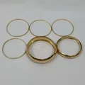 Detailed view of six gold-tone alloy bangle bracelets featuring varying thicknesses. - Gold Polished Multi-size 6-Piece Set (9991)
