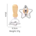 Star-shaped zinc alloy cookie cutter with a wooden handle, measures 10cm by 6.5cm - Star