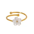 Close-up of elegant 18k gold plated titanium steel ring with white shell cherry blossom - Ring / Gold