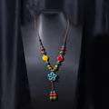 Handmade ethnic style ceramic beaded necklace with flower pendant and brown woven rope strap. - X470-14 Blue Star