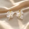 Elegant white petal earrings with a soft pearlescent finish and golden studs - White Pearlescent Texture Layered Petal Style (E5872)