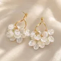 Elegant gold twisted earrings featuring delicate clustered translucent white petals - Gold Twisted Spiral Petal Cluster Style (E3337)