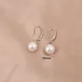 Elegant silver pearl drop earrings with 10mm beads on champagne satin background - 10mm / 10mm Artificial Pearl Silver Hook Style (E8210)