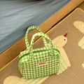 Close-up view of a cute green and white checkered tote bag with mimi label in home room - Green Checkered