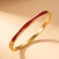 Elegant gold-plated stainless steel bangle featuring channel-set square red gemstones. - Gold Color With Red Zirconia Style (44-E-6)