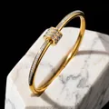 Elegant gold-toned stainless steel bangle set with sparkling zircons on marble base - Gold Slim Waist Bangle