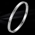 Elegant minimalist silver titanium steel bangle featuring a unique segmented geometric design - Silver Grid/Geometric