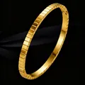Elegant gold titanium steel bracelet with a segmented geometric architectural design. - Gold Grid/Geometric
