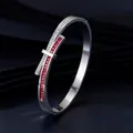 Macro view of bow design silver bangle with red square stones and rhinestones - Steel Color + Pink Zirconia