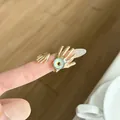 Detailed view of a vintage gold-toned evil eye ring featuring a unique hand-shaped design - Luxury Vintage Hand Holding Eyeball Ring (JZ0916C)