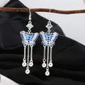 Exquisite ethnic style silver-tone long tassel earrings featuring blue enamel butterflies - Blue Enamel Butterfly Bell Tassel Style (8897/Blue)