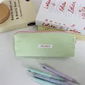 Close-up detail of a pastel green macaron pencil case with Mayrabbit woven label - 19x6x7cm / Green