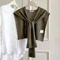 Olive green wool blend knitted shawl shrug worn over a white shirt on a hanger - Stone Green